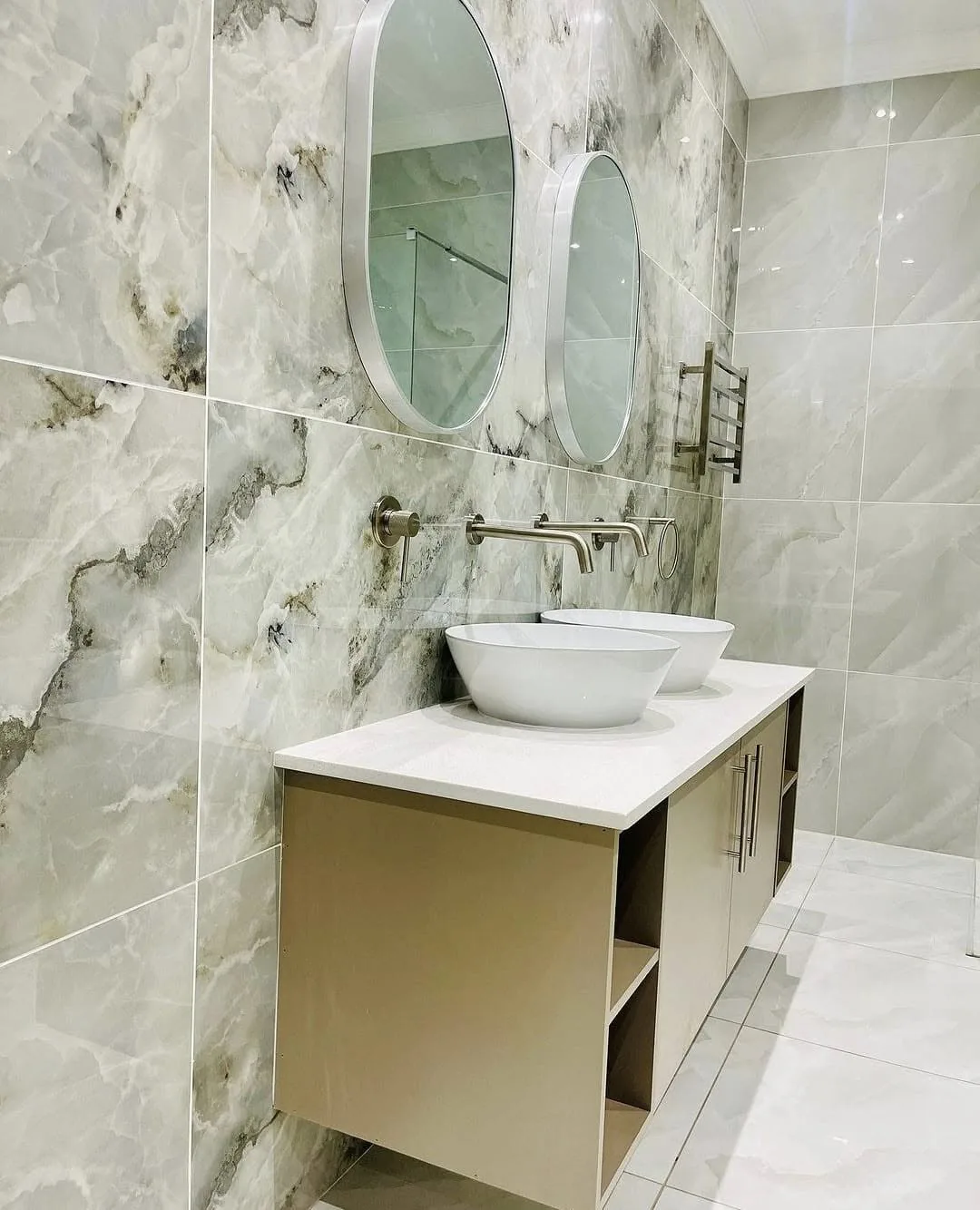 Bathroom renovation with marble-look tile and vessel sink vanity